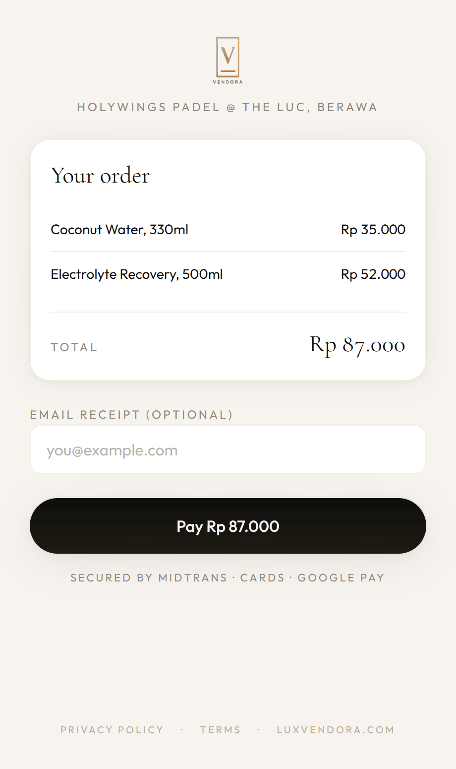 A Vendora payment in progress: an order from Holywings Padel at the Luc, Berawa showing coconut water and an electrolyte recovery drink totalling Rp 87.000, with a Pay button.
